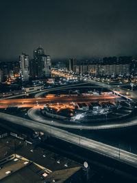 High angle view of illuminated city against sky at night