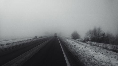 Railroad tracks against sky during winter