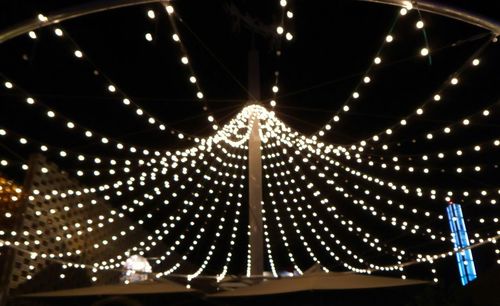 Low angle view of illuminated lights at night