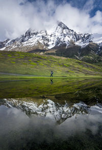 Reflection of snowcapped mountains on calm lake