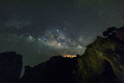 Low angle view of mountain against sky at night