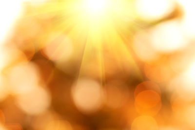 Defocused image of lights against sky during sunset