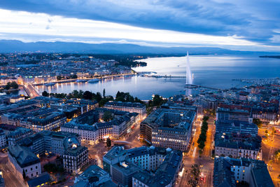 High angle view of city lit up at dusk