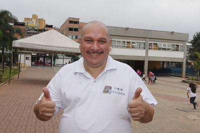 Portrait of smiling man standing on street in city