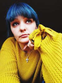 Close-up of woman in yellow sweater