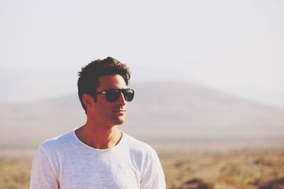 Man wearing sunglasses standing outdoors