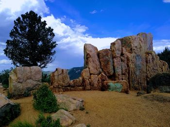 Rock formations on landscape against sky