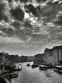 Boats in river with buildings in background