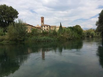 Scenic view of lake by building against sky