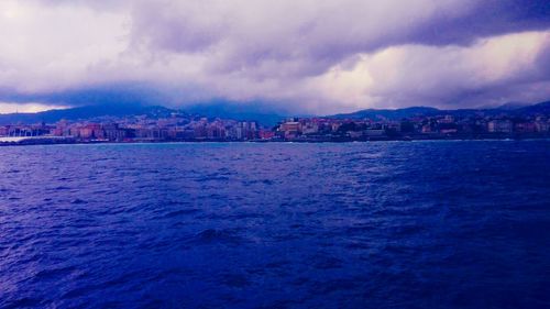 View of town against cloudy sky