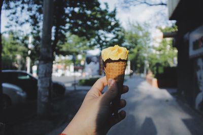 Close-up of hand holding ice cream cone