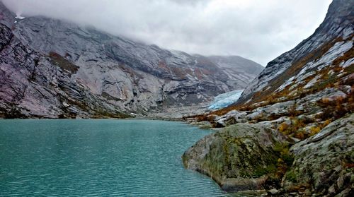 Scenic view of lake and mountains against sky