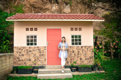 Woman standing against building