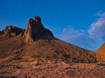 Rock formations on landscape against sky