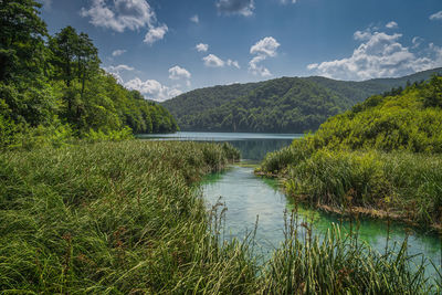 Scenic view of lake and mountains against sky