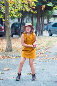 Portrait of smiling young woman standing outdoors