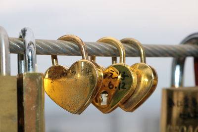 Close-up of padlocks hanging on railing