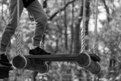 Low section of person on obstacle course in forest