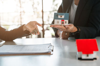 Midsection of businessman using mobile phone