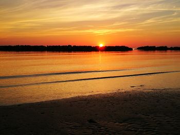 Scenic view of beach against sky during sunset