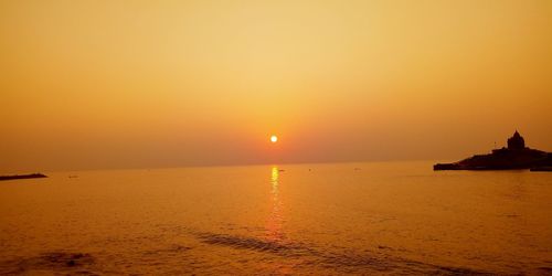 Scenic view of sea against orange sky