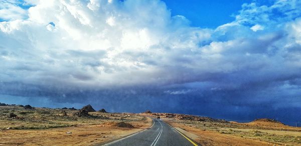 Panoramic view of empty road against cloudy sky