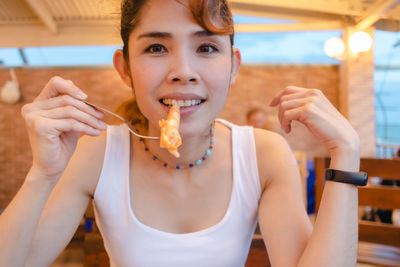 Portrait of happy woman eating food
