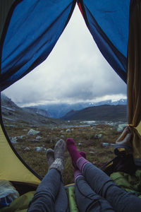 Close up friends in camp at mountain valley concept photo