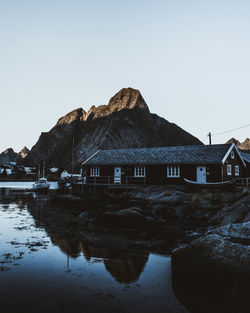 Houses by mountain against clear sky