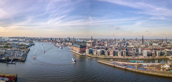 High angle view of river by buildings in city against sky