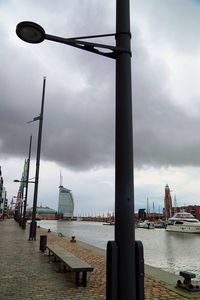 View of harbor against cloudy sky