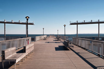 Pier over sea against clear sky