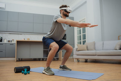 Side view of woman exercising in gym