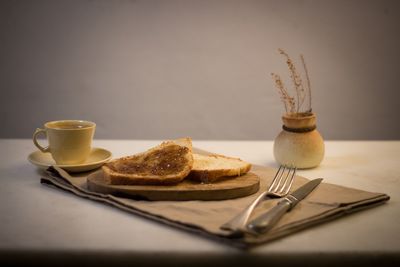 Cup of coffee and spoon on table