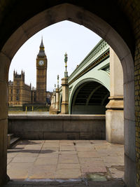 Bridge over river against built structures