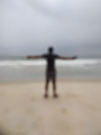 Rear view of person standing on beach