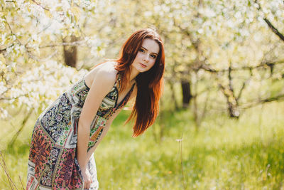 Portrait of young woman standing outdoors