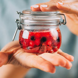 Fruit fermentation. woman holding jar with fermented fruit.