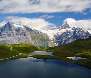 Scenic view of lake and mountains against sky