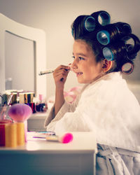 Girl applying make-up at home