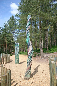 Statue against trees and plants in forest