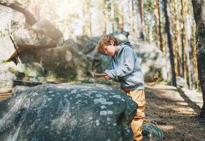 Side view of man standing on rock