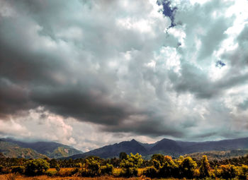 Scenic view of mountains against cloudy sky