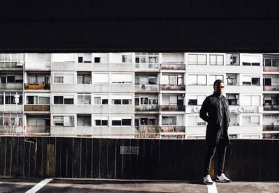 Man standing in front of office building