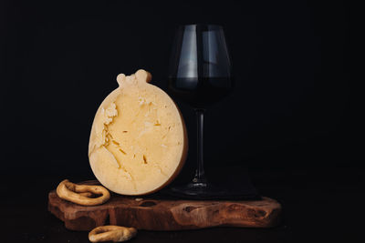 Close-up of beer glass against black background