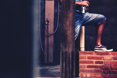 Low section of man standing on street