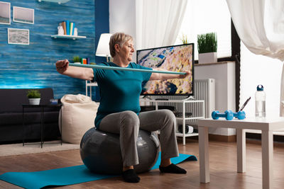 Senior woman working out at home