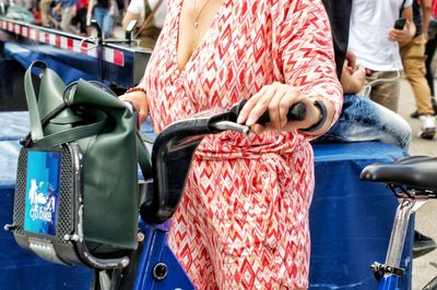 Midsection of woman holding umbrella