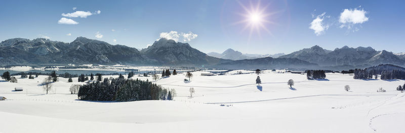 Panoramic view of snow covered mountains against sky