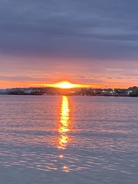 Scenic view of sea against romantic sky at sunset